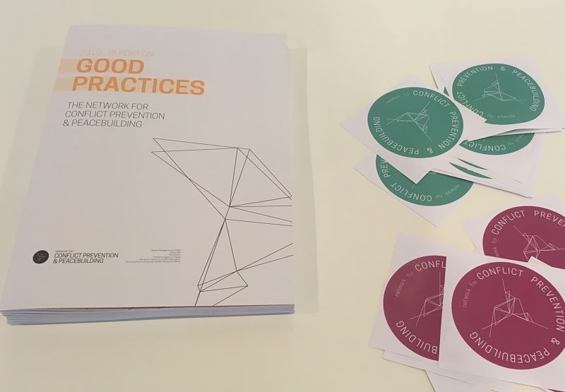 Photo of the Good Practices report and stickers